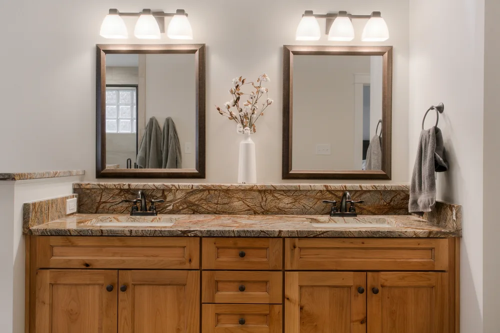Twin vanity with a quartz countertop and backsplash