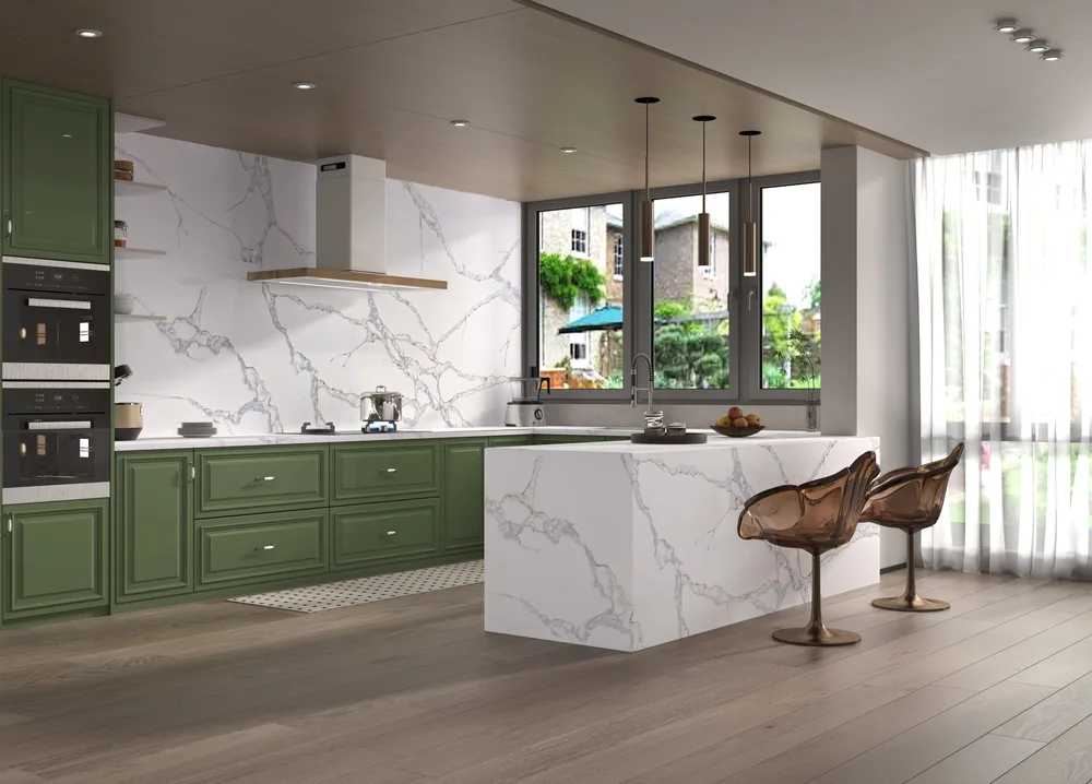 Green kitchen cabinetry with a white veined waterfall island and matching backsplash