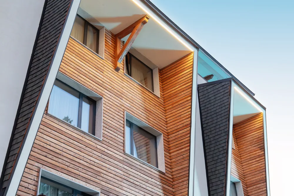Slatted timber facade above a stone plinth