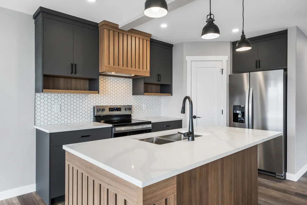 Charcoal and timber kitchen with a pale veined stone island and undermount sink